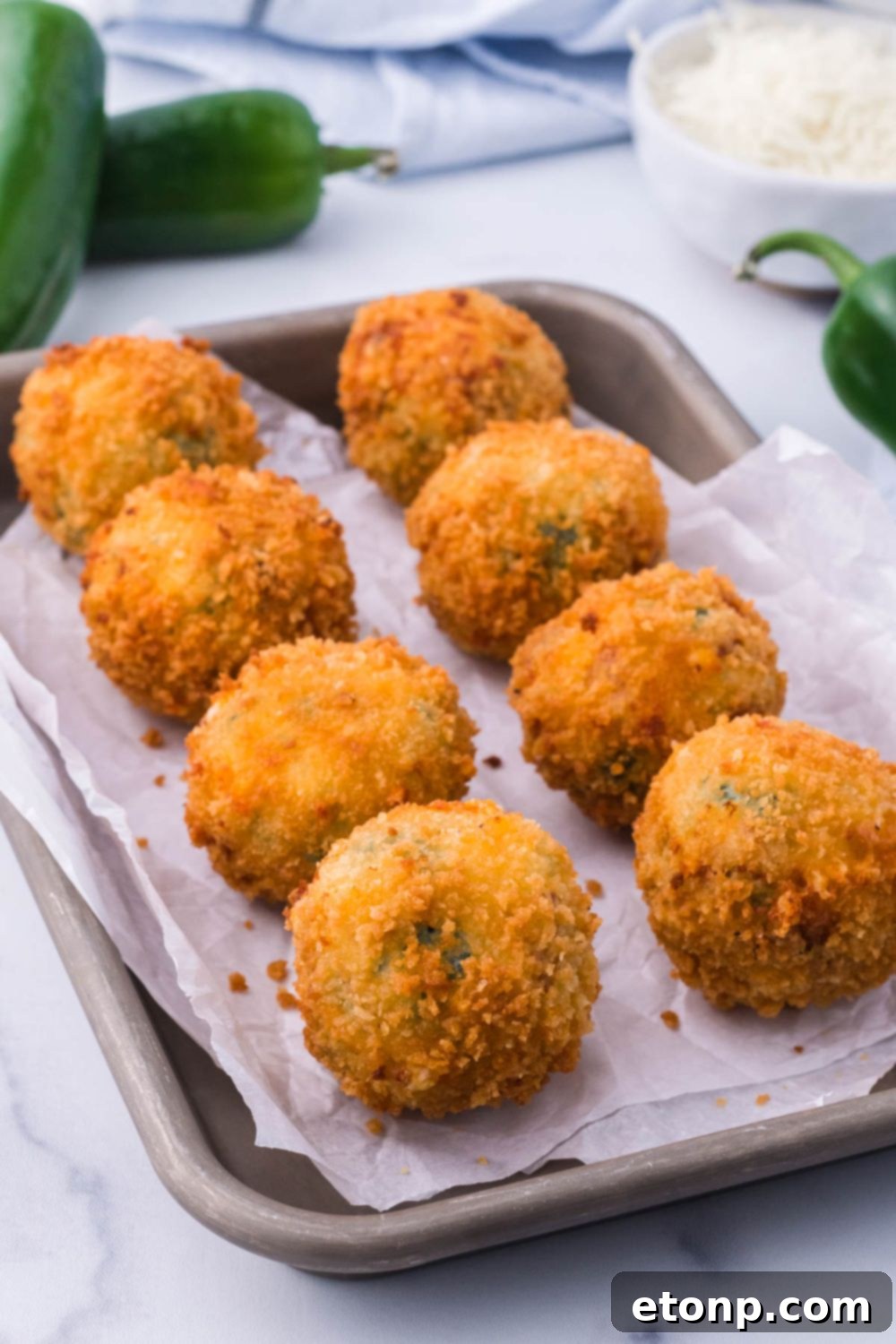 Crispy Jalapeno Cream Bombs 3 Jalapeno Popper Bites on a baking tray on table