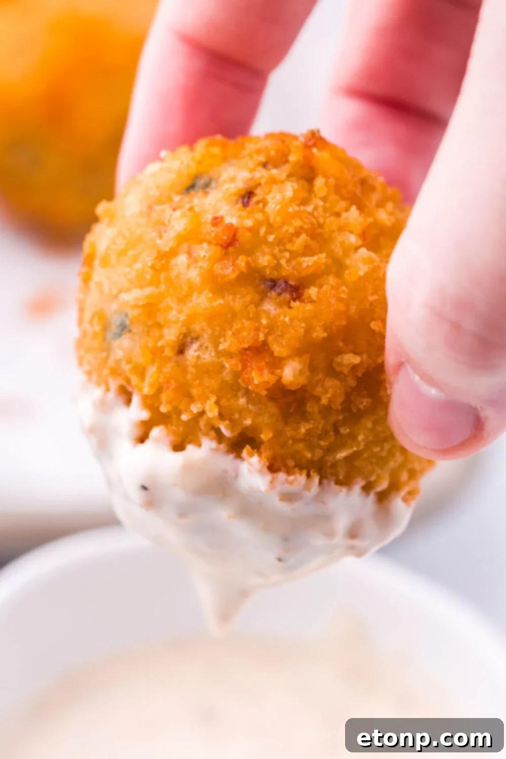 Crispy Jalapeno Cream Bombs 4 Jalapeno Popper Bite being dipped in ranch dressing