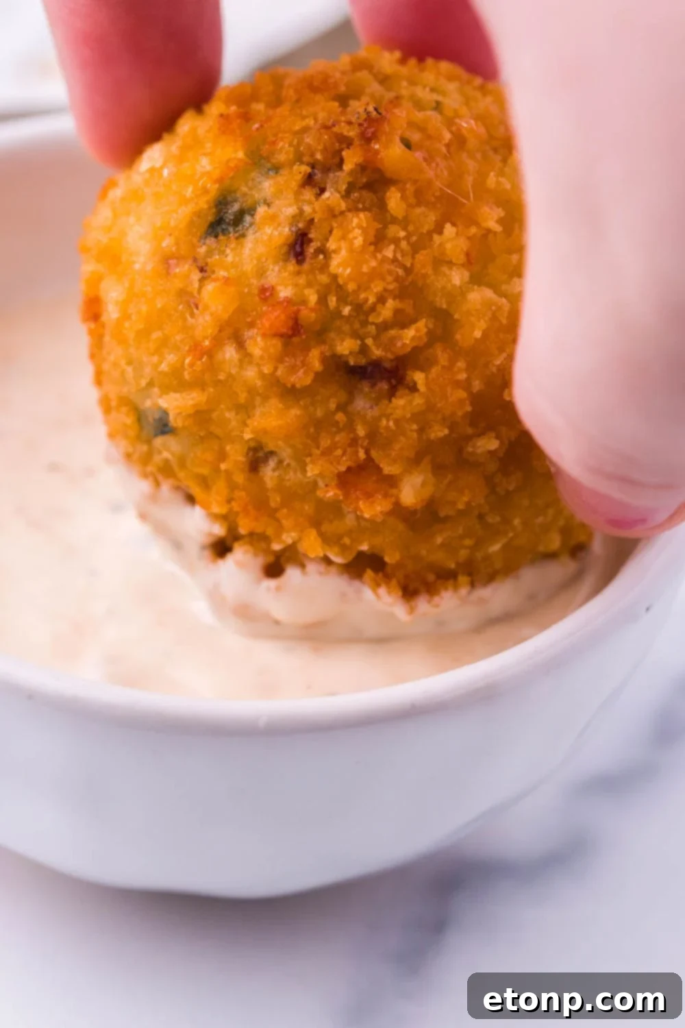 Crispy Jalapeno Cream Bombs 8 Jalapeno Popper Bite being dipped in sauce