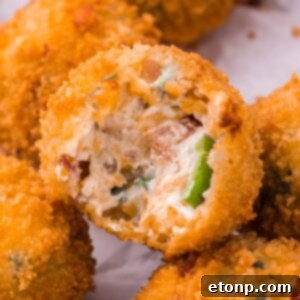 Jalapeno Popper Bite with a bite taken out sitting on table
