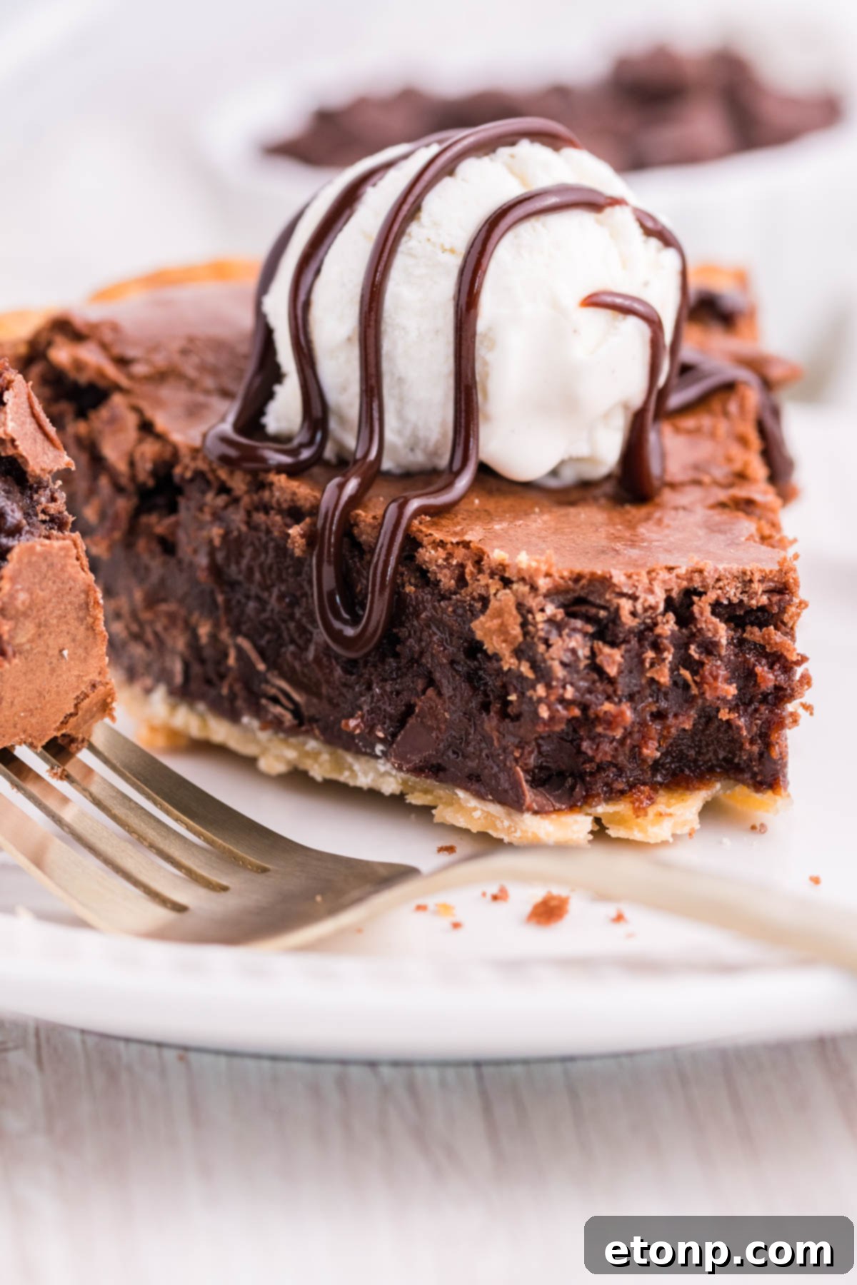 A whole Fudge Brownie Pie on a cooling rack, showcasing its golden-brown crust and rich, dark top.