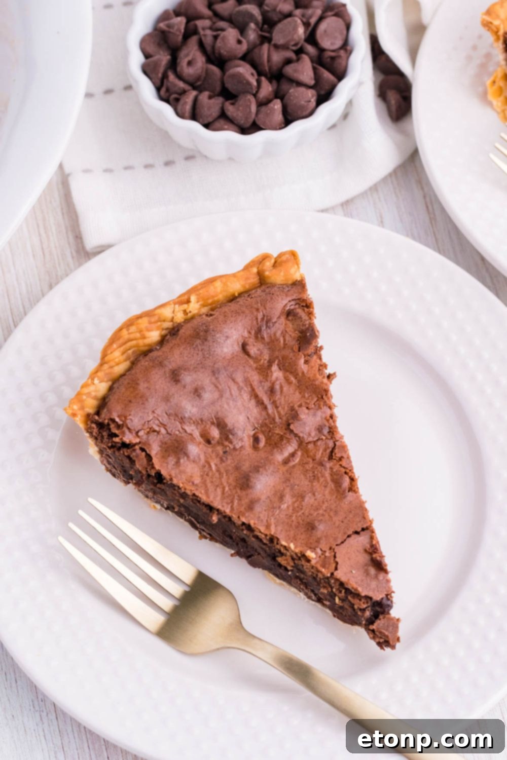 Individual slices of Fudge Brownie Pie neatly arranged on a white plate, showcasing its uniform fudgy texture.