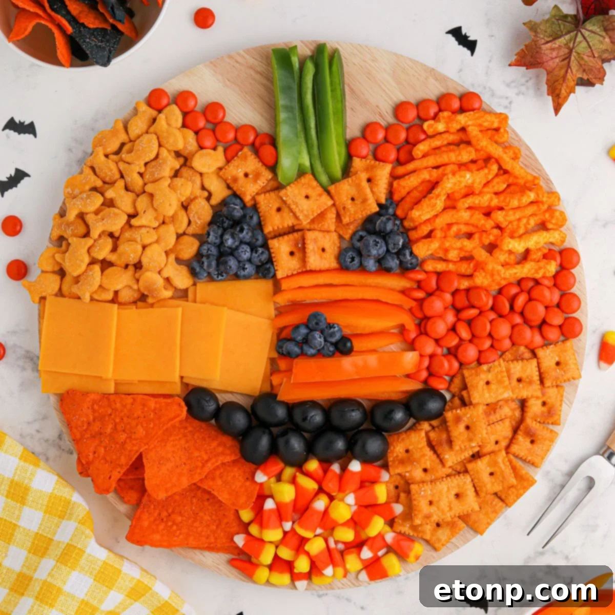 Overhead shot of a Pumpkin Charcuterie Board, clearly showing the pumpkin shape and face details