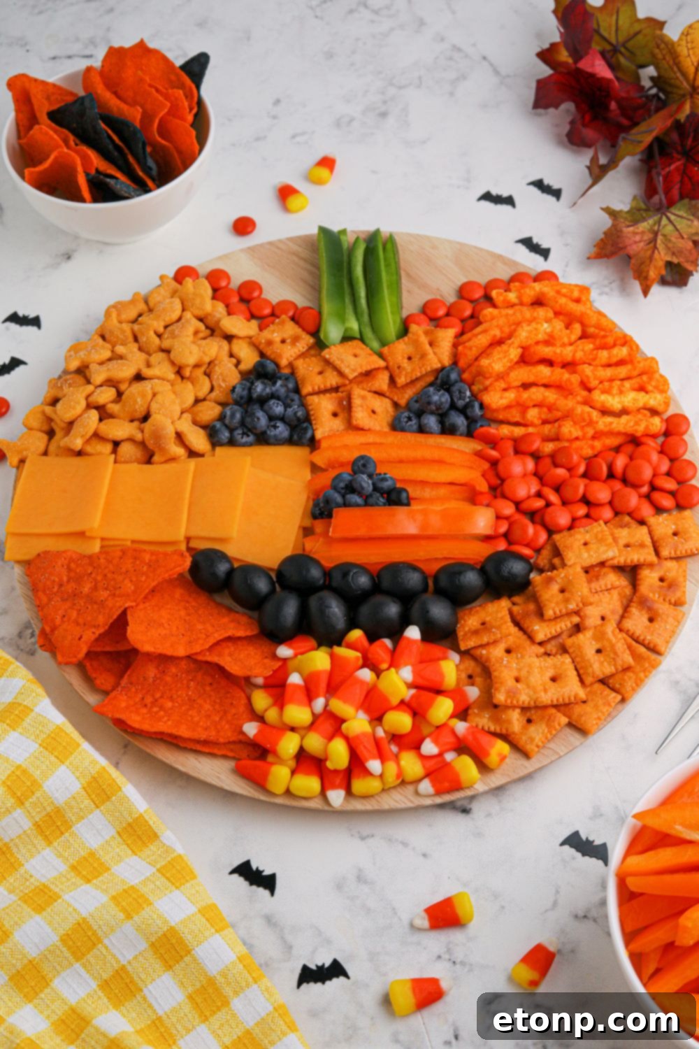 Pumpkin Charcuterie Board displayed on a table with complementary items around it