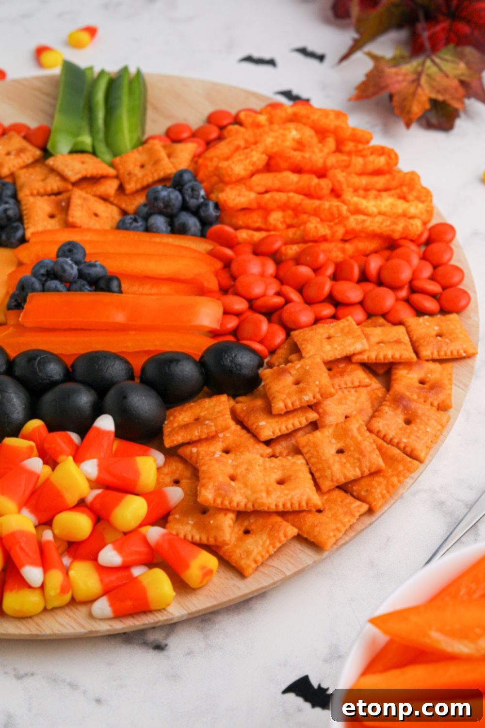 Pumpkin shaped appetizer board presented on a table