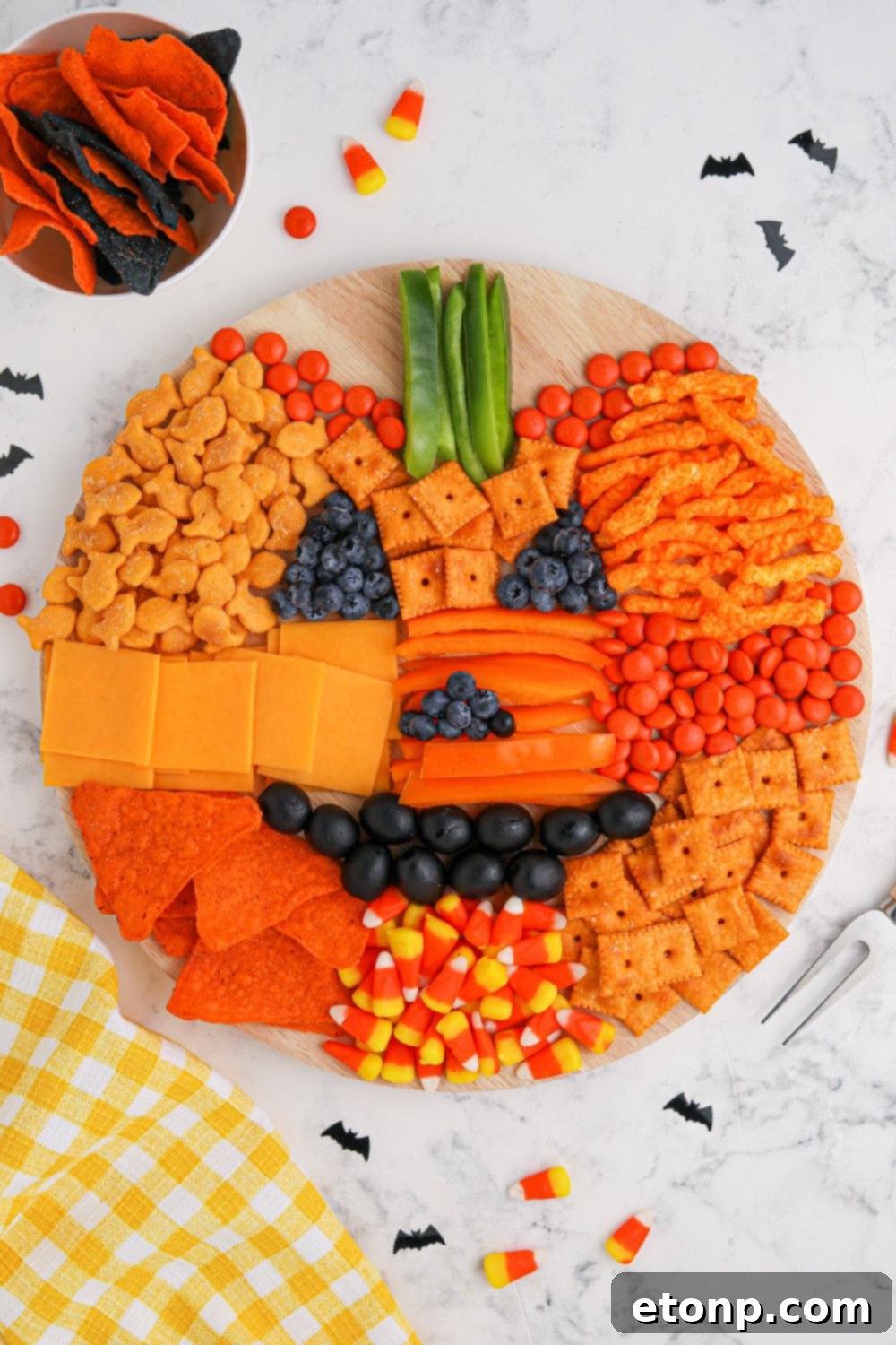 Overhead view of a charcuterie pumpkin board, perfectly arranged and ready to be enjoyed