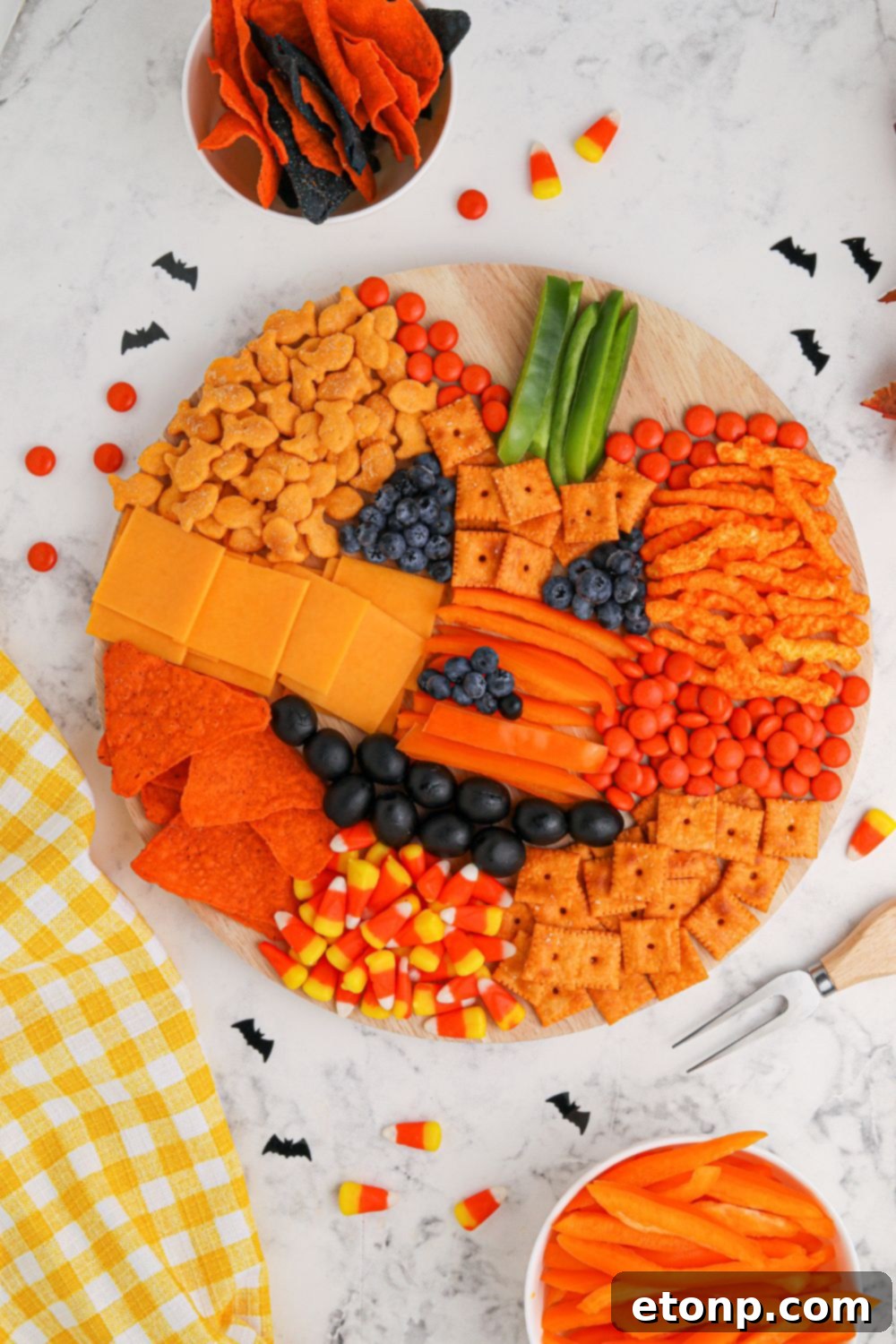 Pumpkin shaped veggie tray, a component of a larger charcuterie board spread