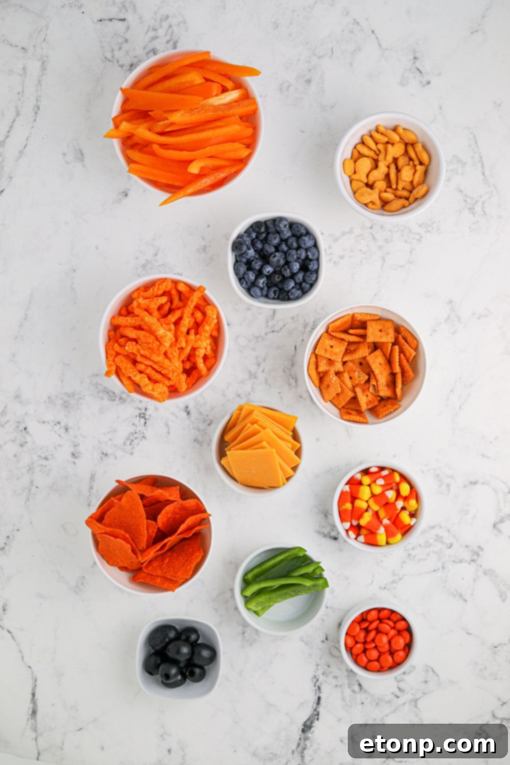 Pumpkin Charcuterie Board ingredients neatly arranged in small bowls, ready for assembly