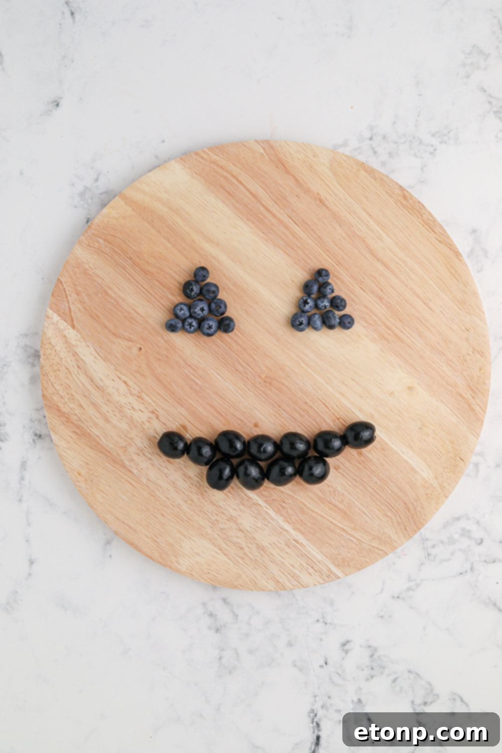 Close-up of a perfectly formed jack-o-lantern face on a charcuterie board