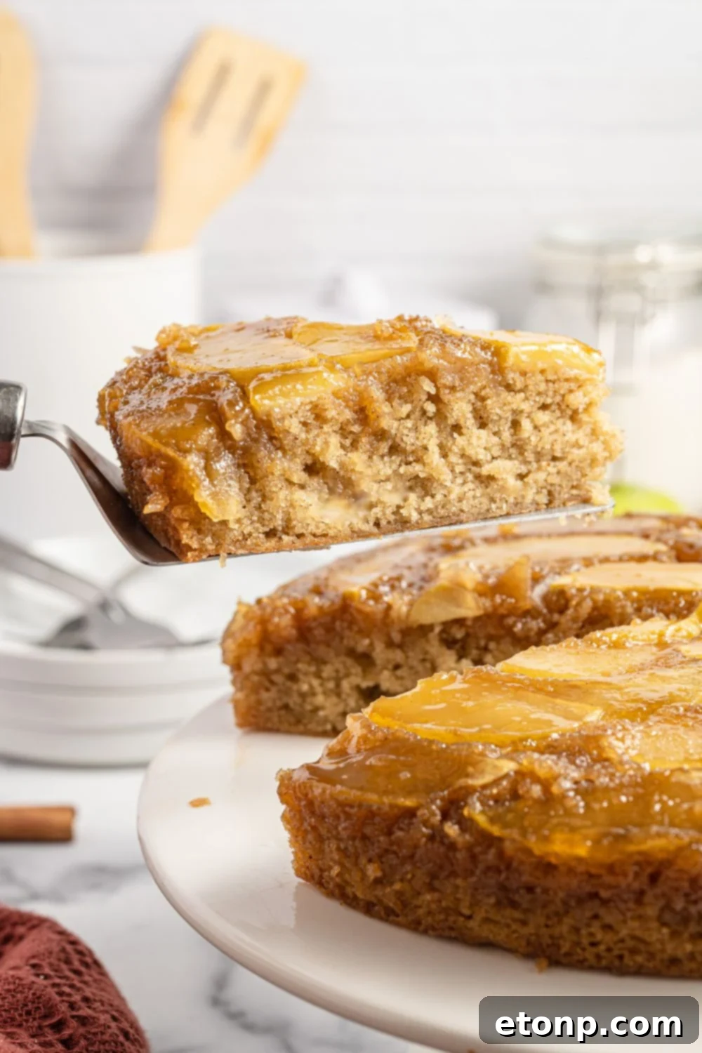 cake on a platter with a slice of cake on spatula 