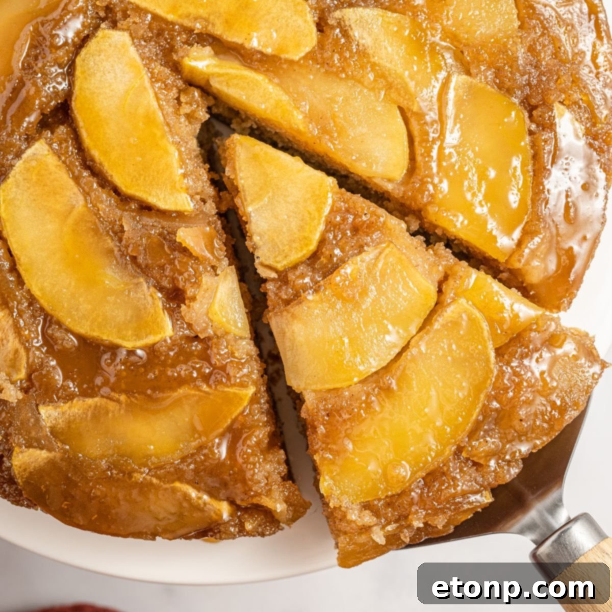 Apple Upside Down Cake with a slice being lifted up