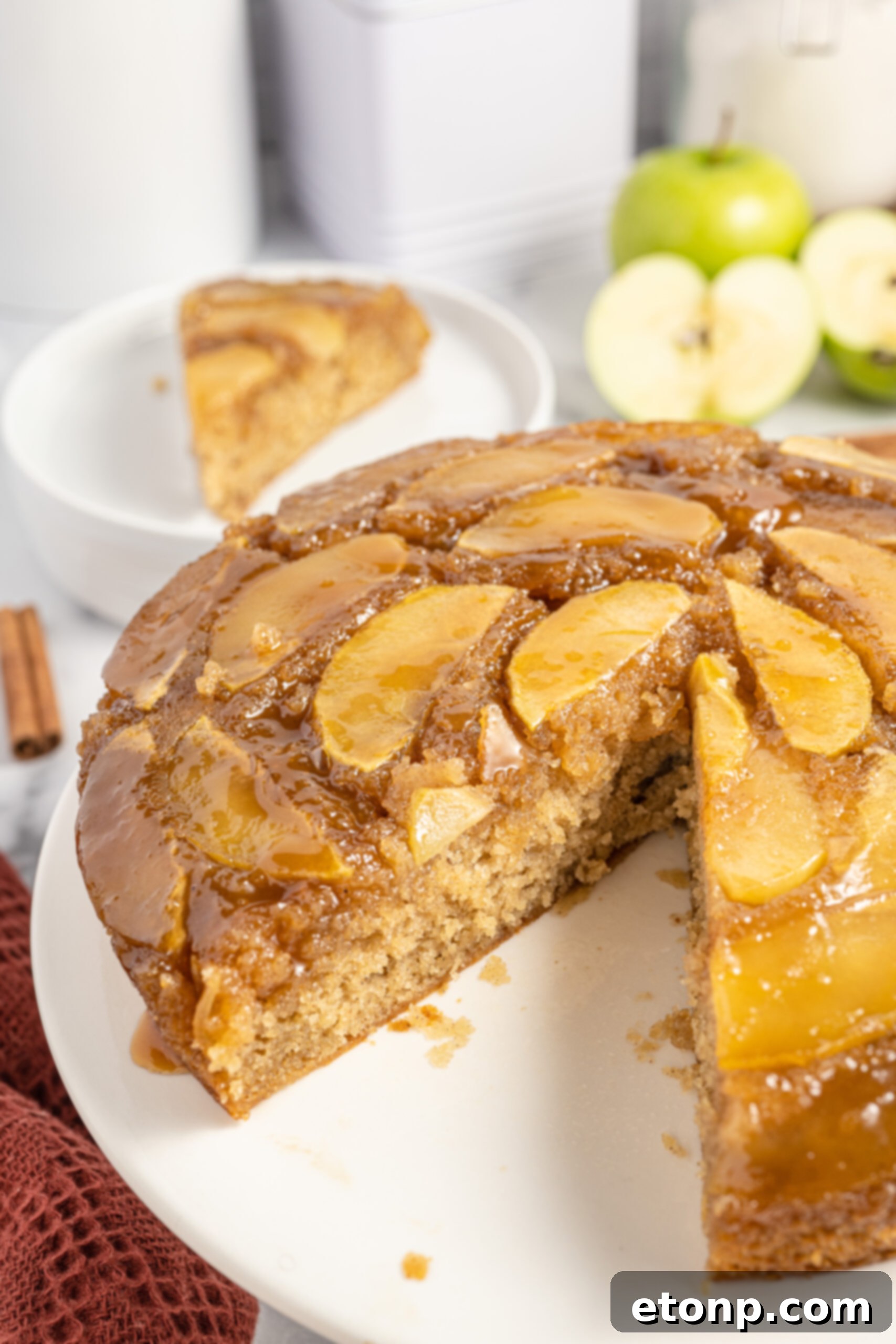 The cake on a white serving platter with a slice removed to show texture 