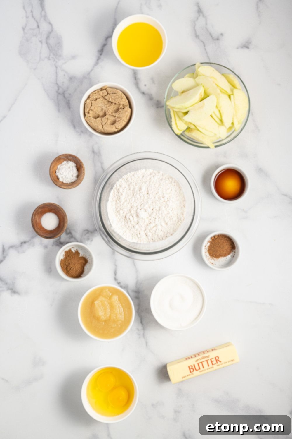 overhead shot of ingredients for an apple upside down cake in bowls on table