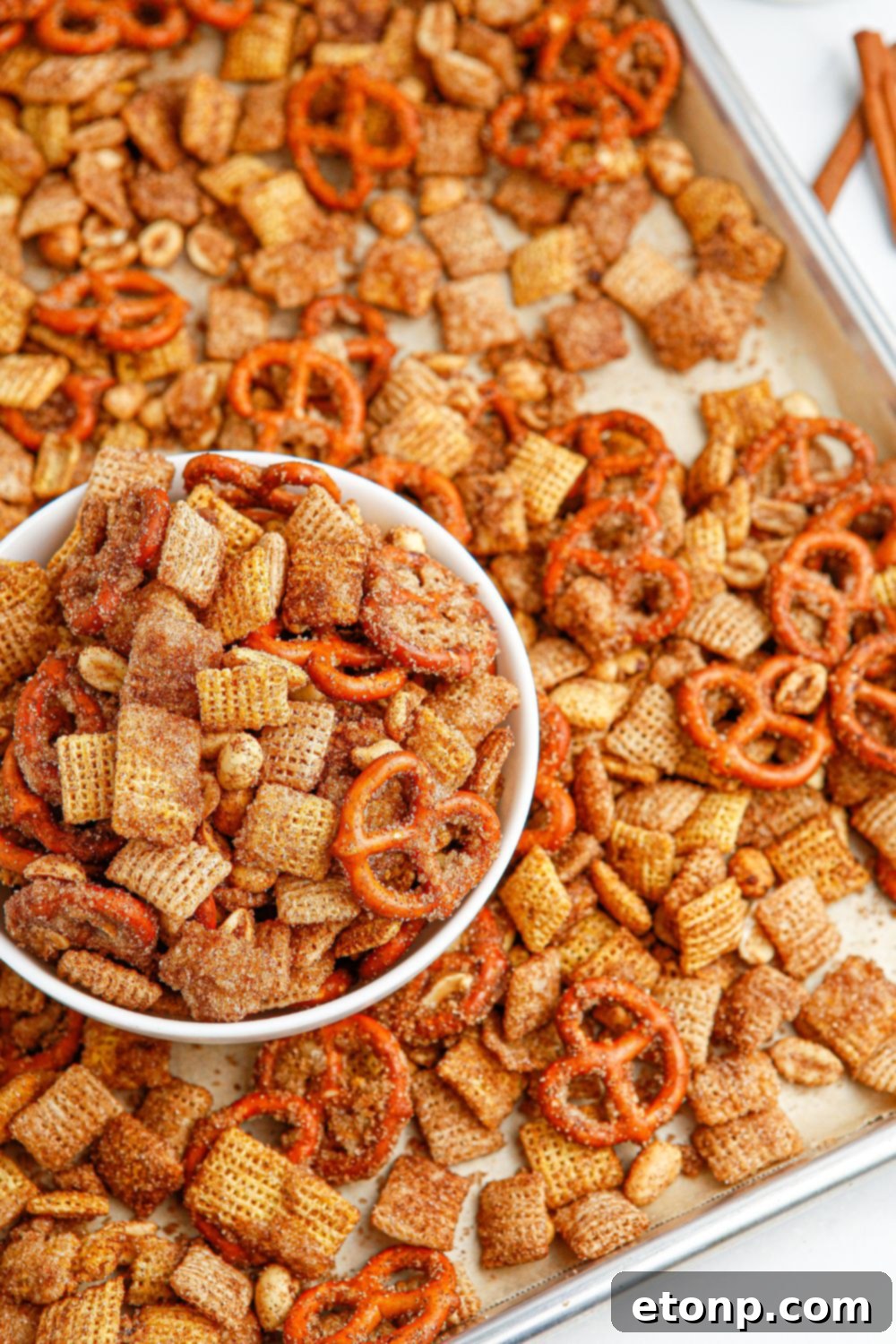 Another view of the cinnamon Chex mix filling a tray and a separate bowl, ready for enjoyment.