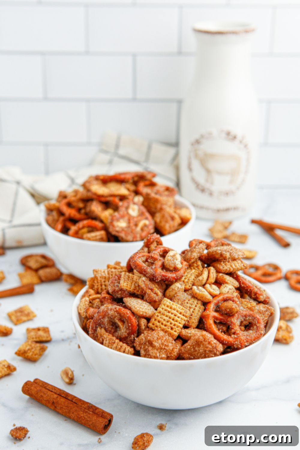 An extremely close-up view of the Chex mix, highlighting the glistening cinnamon and sugar coating on each piece.