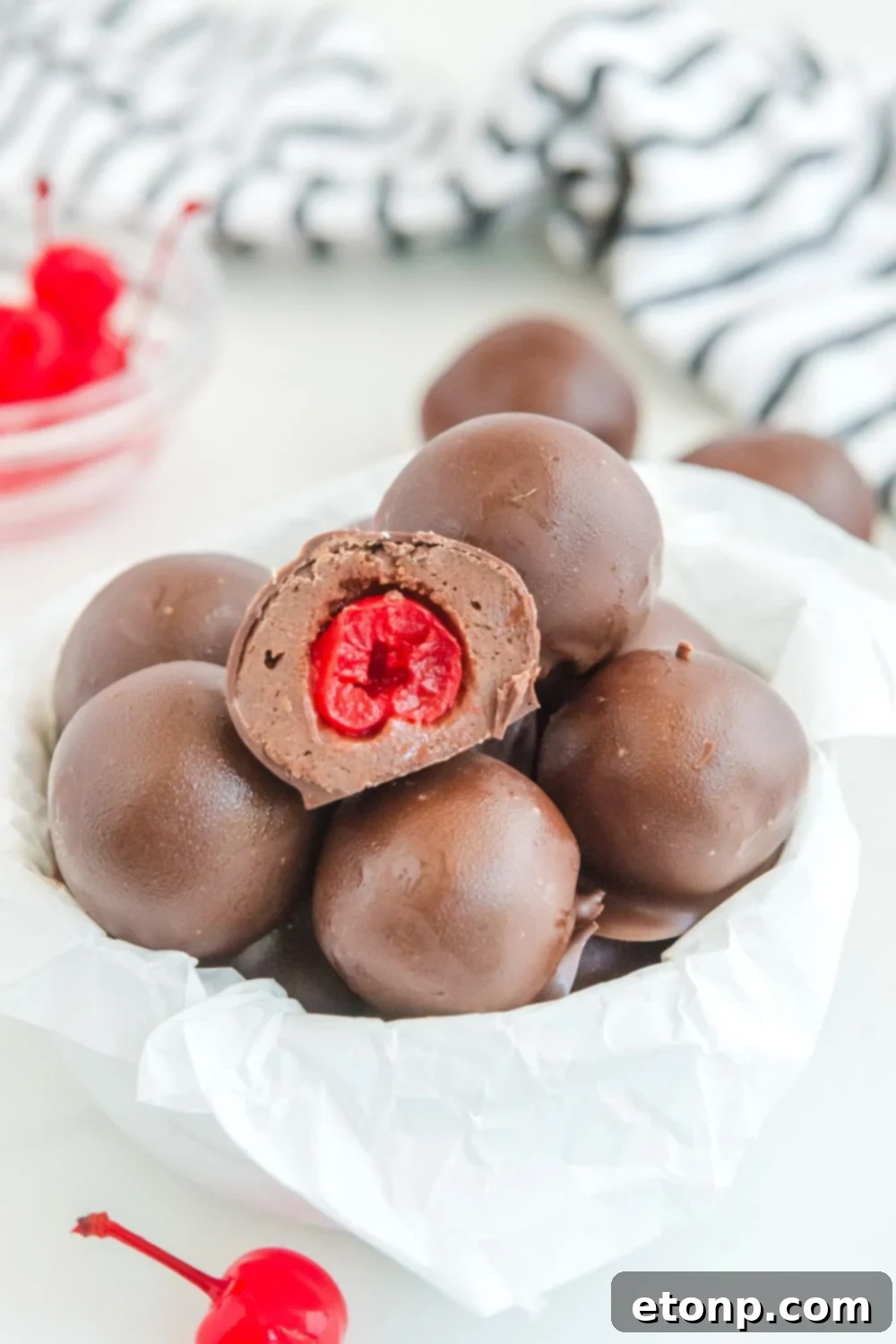 Fudgy Cherry Chocolate Bombs 15 brownie bites in bowl with a cherry bite showing