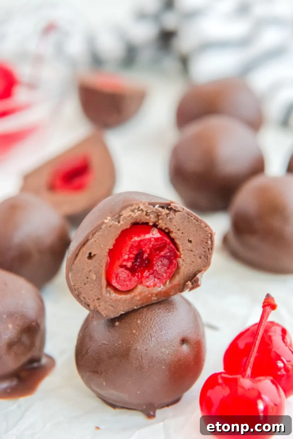Fudgy Cherry Chocolate Bombs 4 brownie bites on counter stacked on top of each other