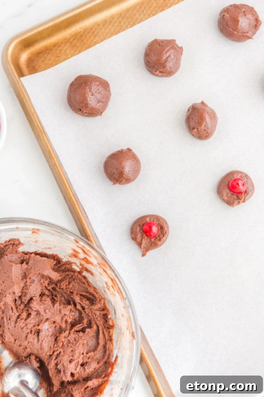 Fudgy Cherry Chocolate Bombs 9 cookie sheet with brownie bites and a cherry sitting in center of balls