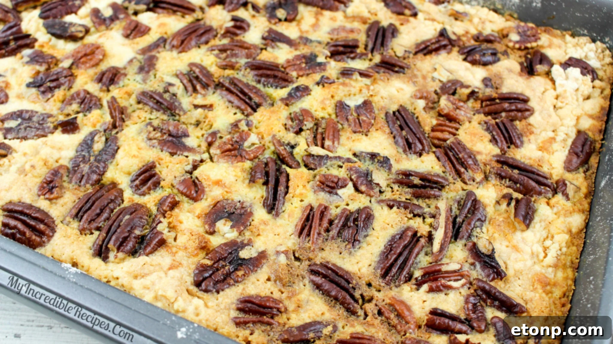 Simply Divine Pumpkin Pecan Dump Cake 12 A slice of Pumpkin Pecan Dump Cake viewed from the side, clearly revealing all three distinct layers: pumpkin, cake, and pecans.