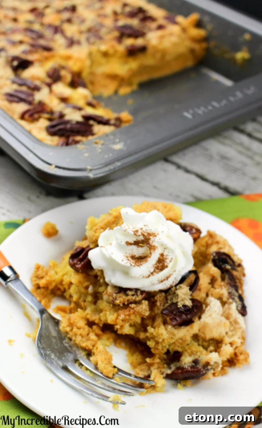 Simply Divine Pumpkin Pecan Dump Cake 13 A generous serving of Pumpkin Pecan Dump Cake on a white plate, highlighting its deliciousness.