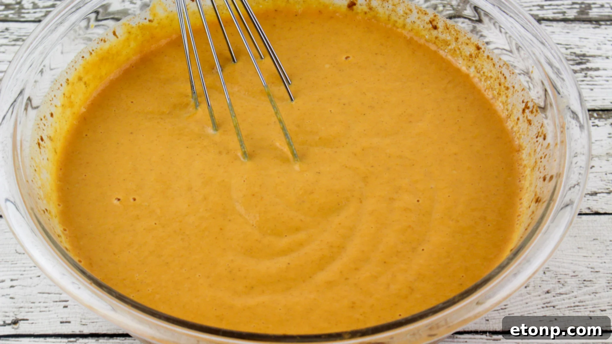 Simply Divine Pumpkin Pecan Dump Cake 5 Overhead view of the Pumpkin Pecan Dump Cake in a baking dish, freshly baked and golden.