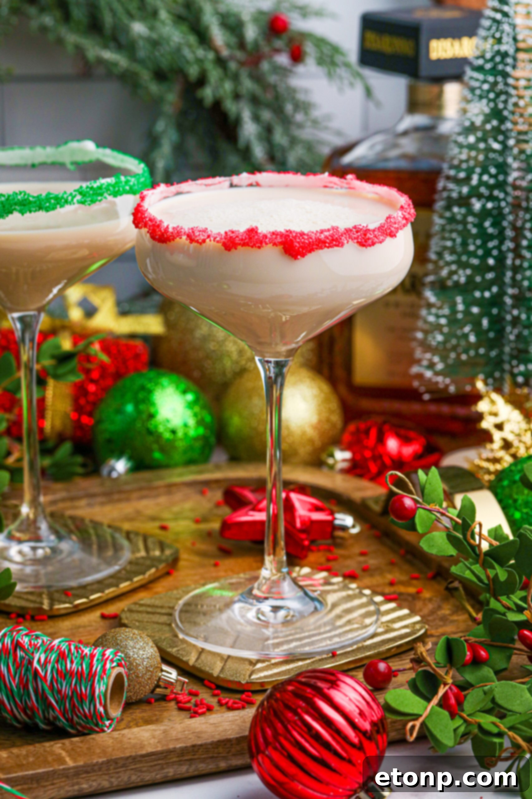 Sugar Cookie Cocktail in a glass with a red sugar rim on a wooden table 