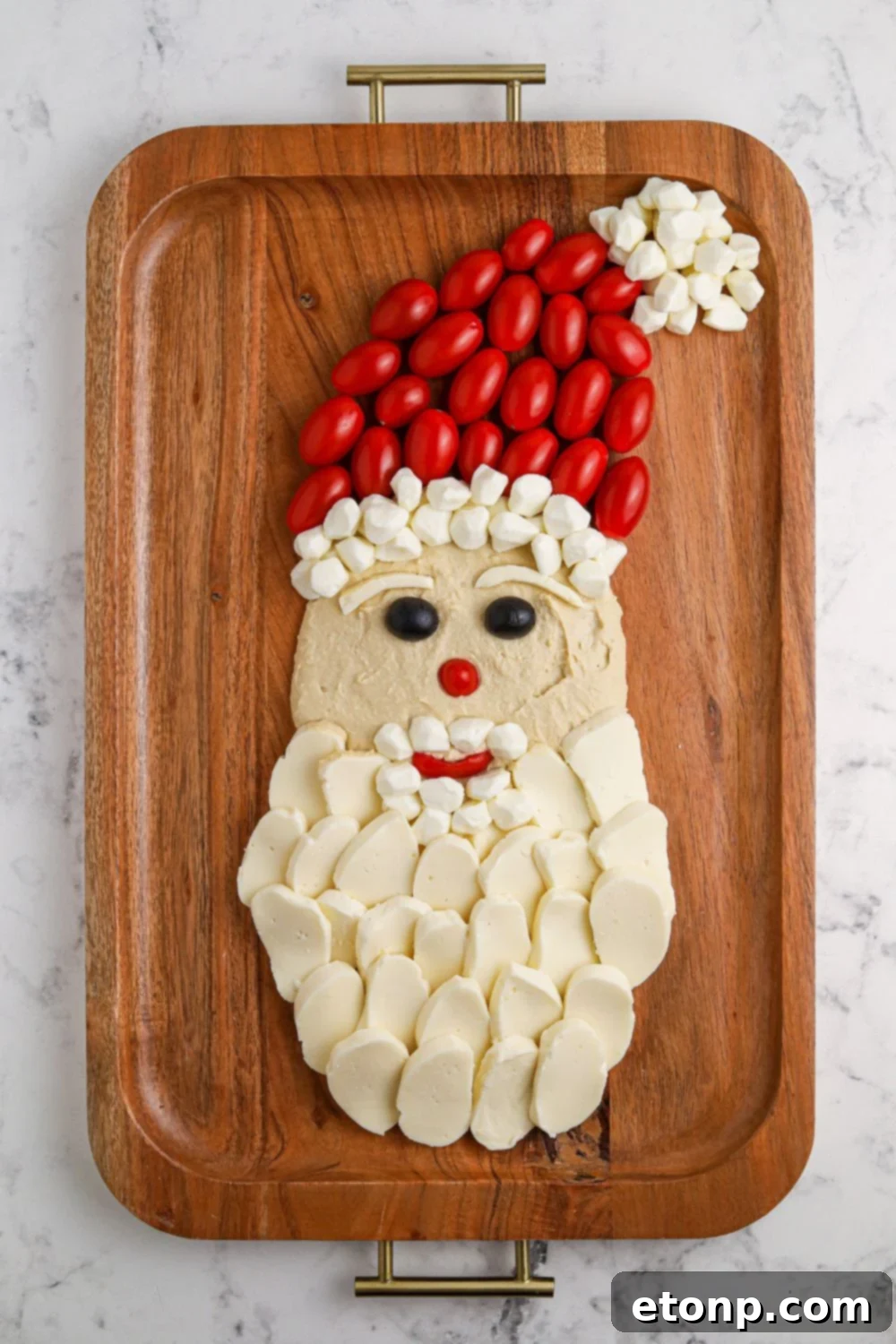 The process of building a Santa tray, with beard and hat elements being added.