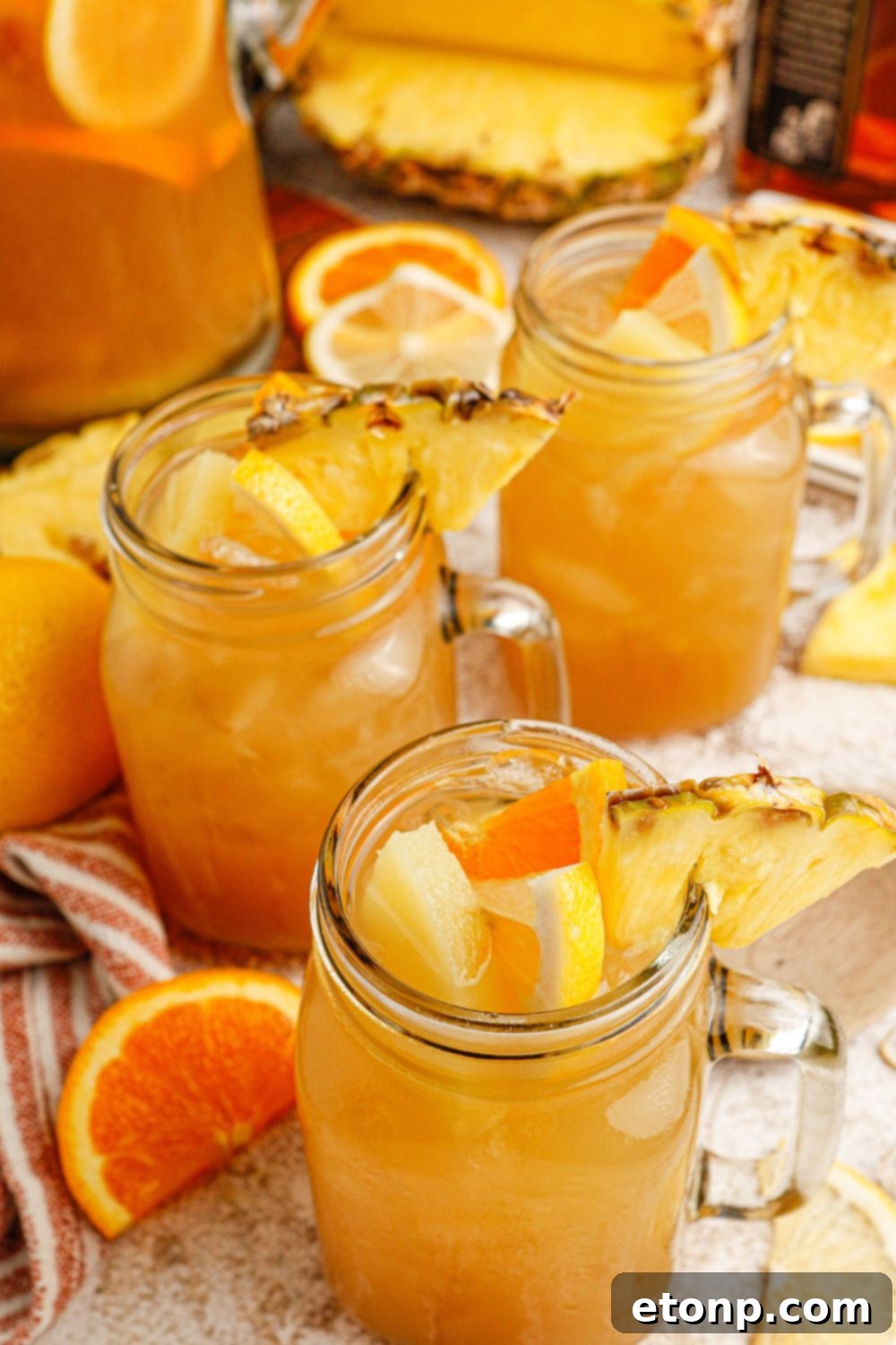 Touchdown Tea in glasses on a table with sliced fruit garnishes