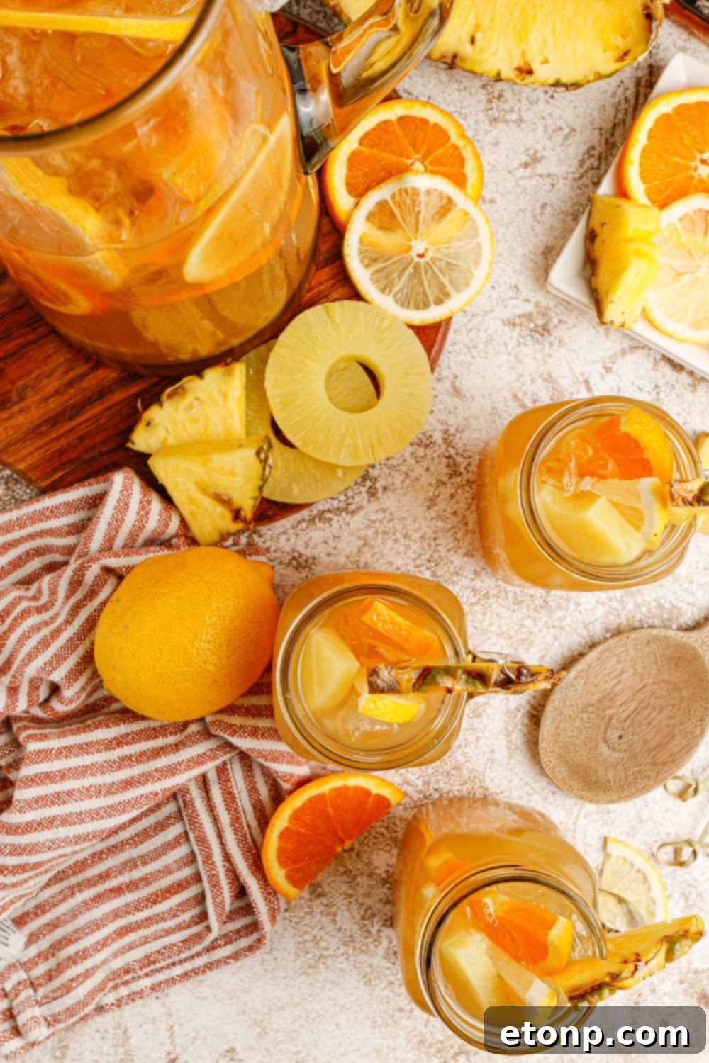 Twisted tea drinks in glasses with a pitcher of the tea mixture