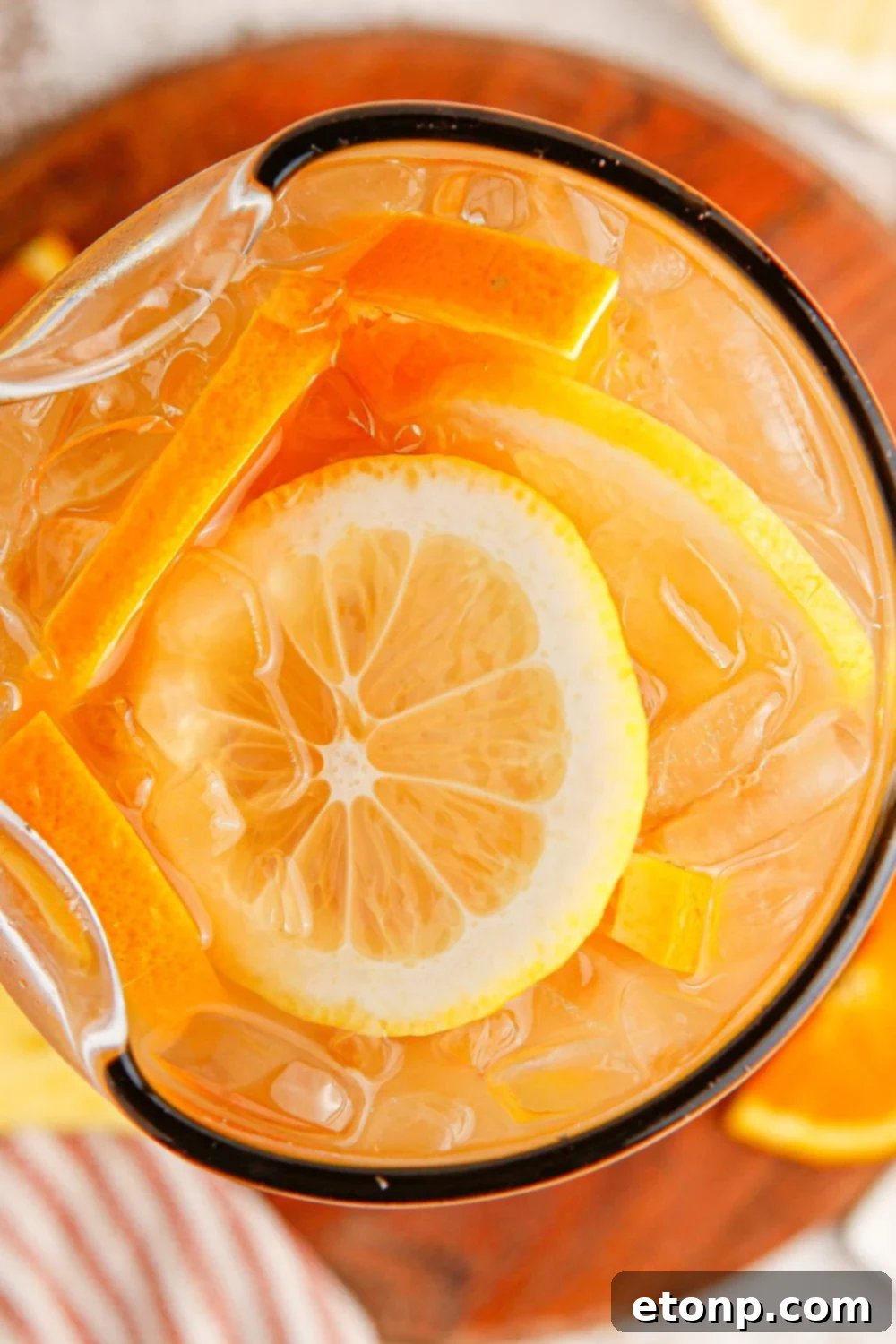 Bourbon tea in a large pitcher with ice and fruit