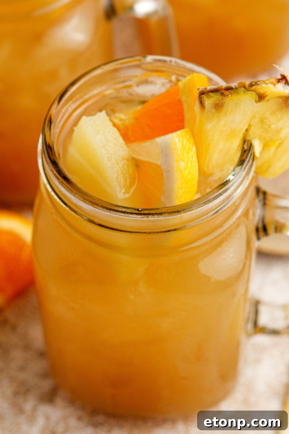 Glass of bourbon iced tea with sliced fruit garnish