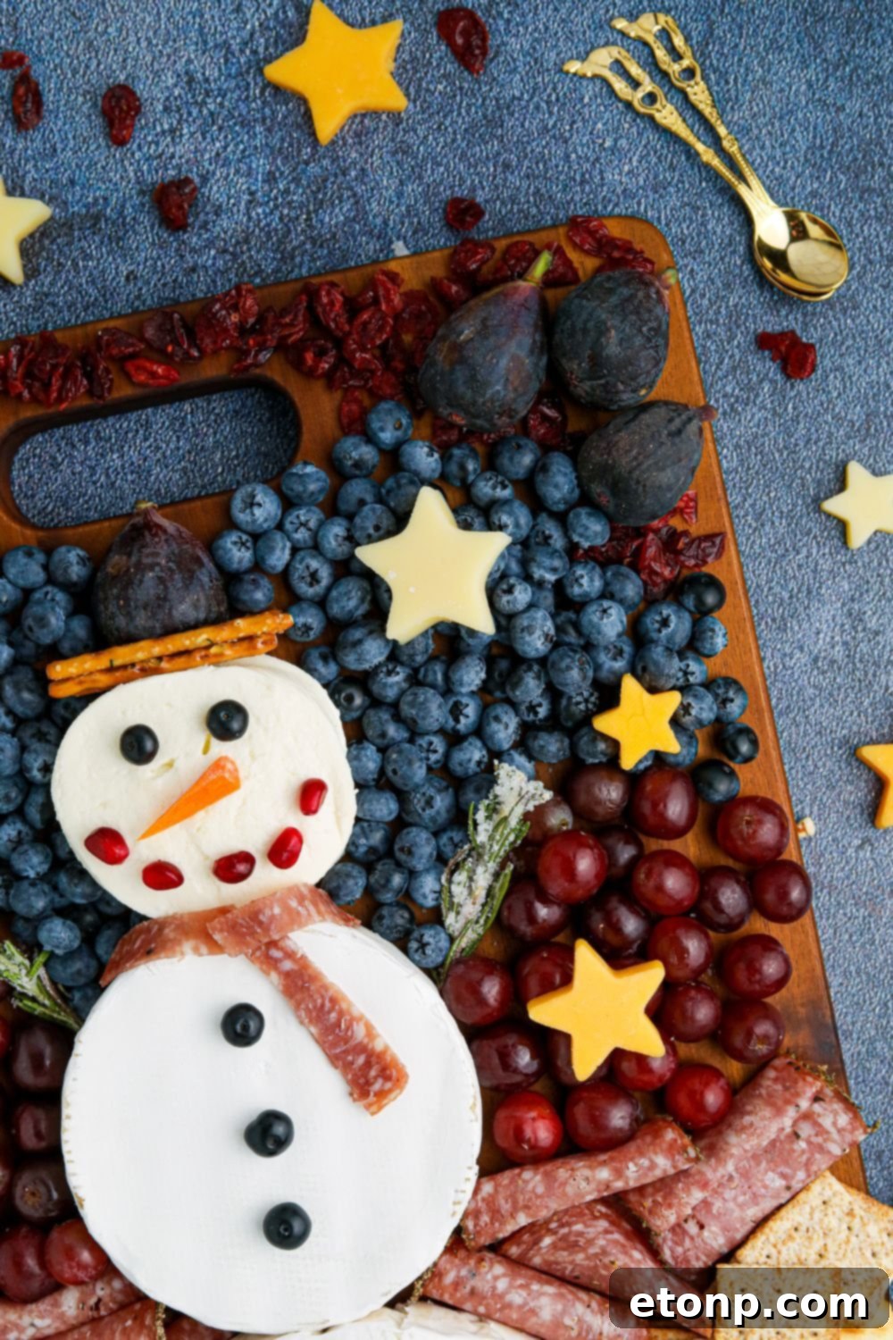 Whimsical Snowman Snack Board 11 Side view of the snowman platter on a table, highlighting the variety of snacks.
