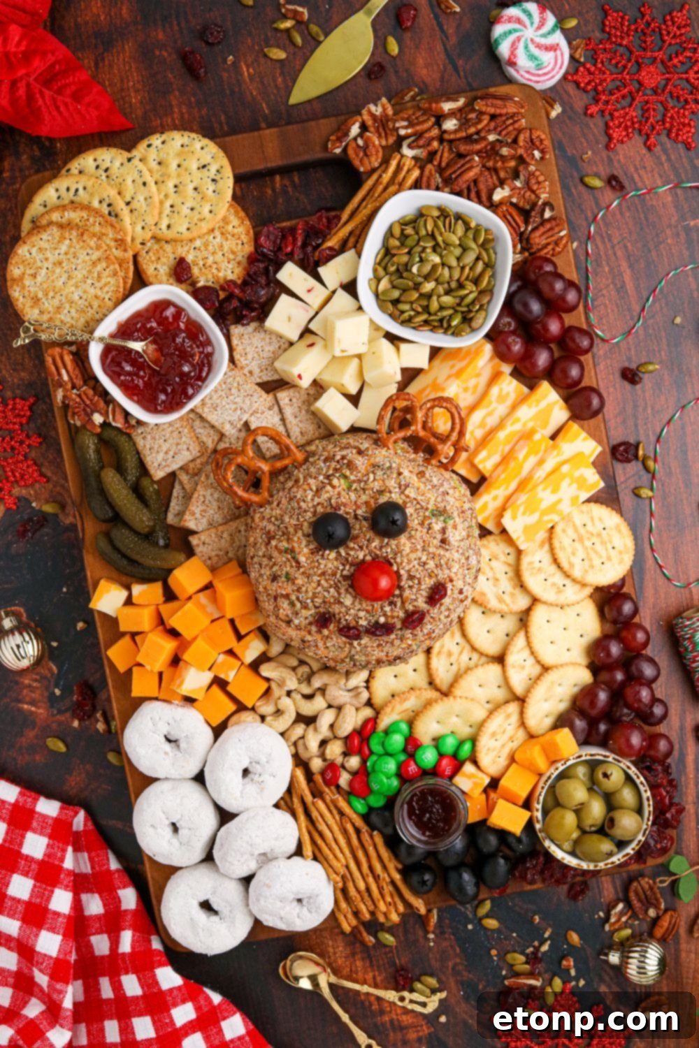 cheeseball on table with snack items around the board 