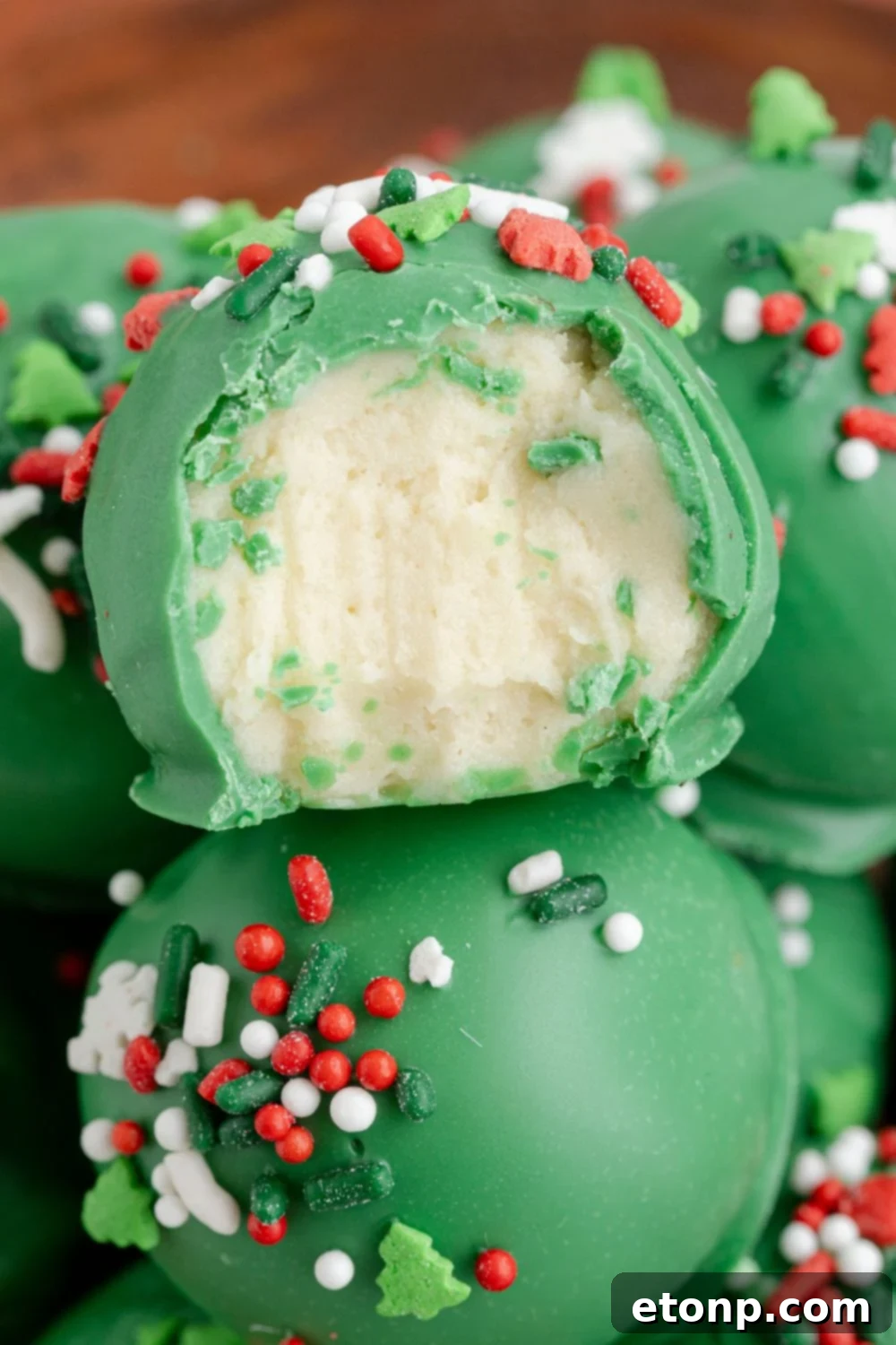 sugar cookie truffles in bowl with a bite taken out of it 