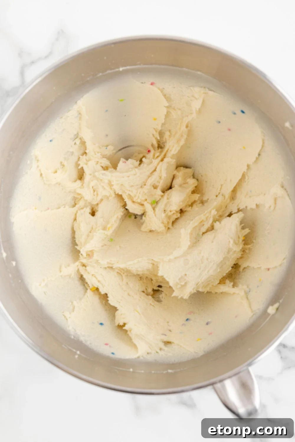 batter of sugar cookie truffles mixed in a mixing bowl 