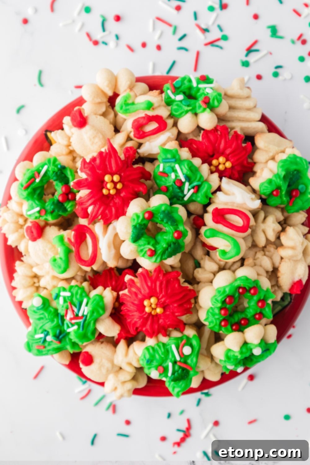 plate with spritzer cookies on it and sprinkles around it