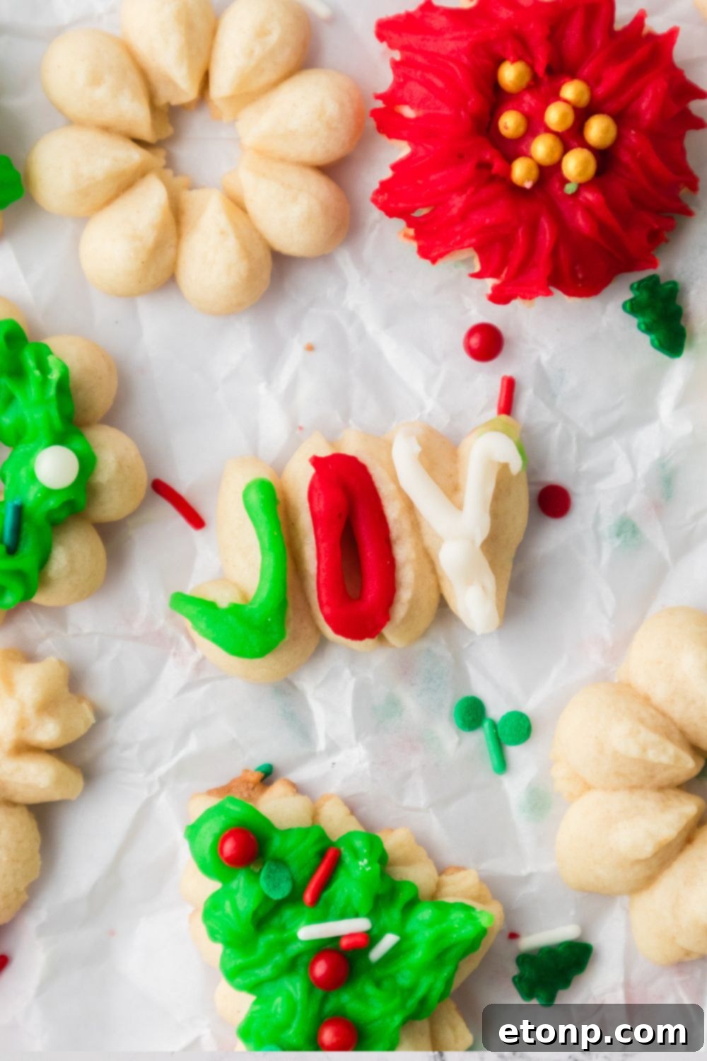 joy worded cookie on table with more cookies around it