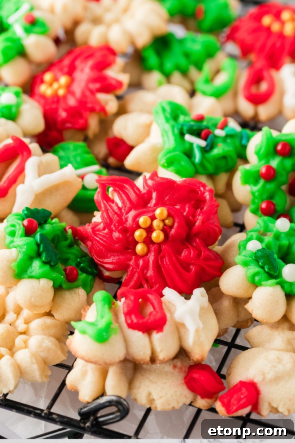 Christmas Spritz Cookies stacked on a cooling rack