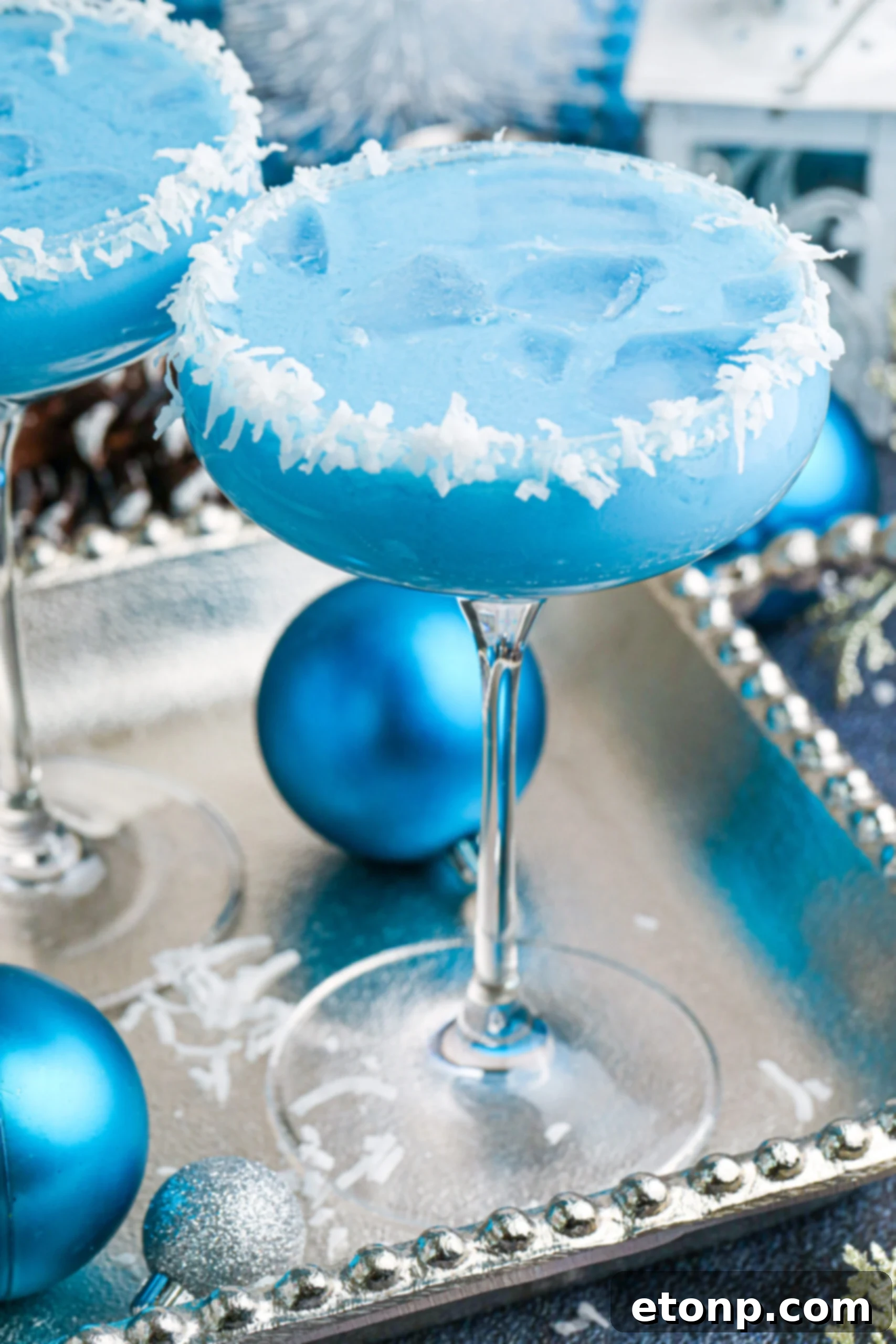 blue Christmas cocktail with a coconut rim