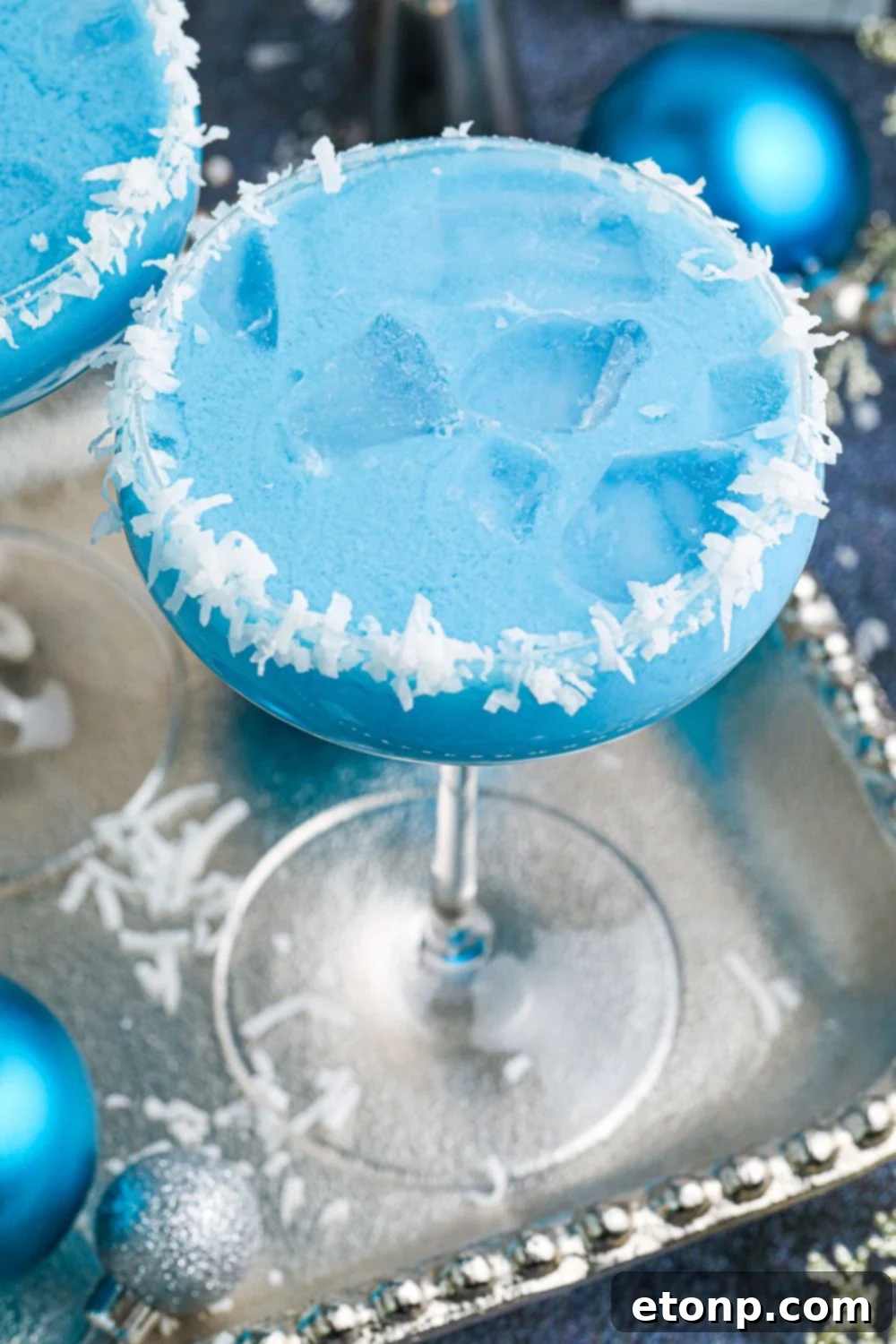 side view of blue drink on a silver platter