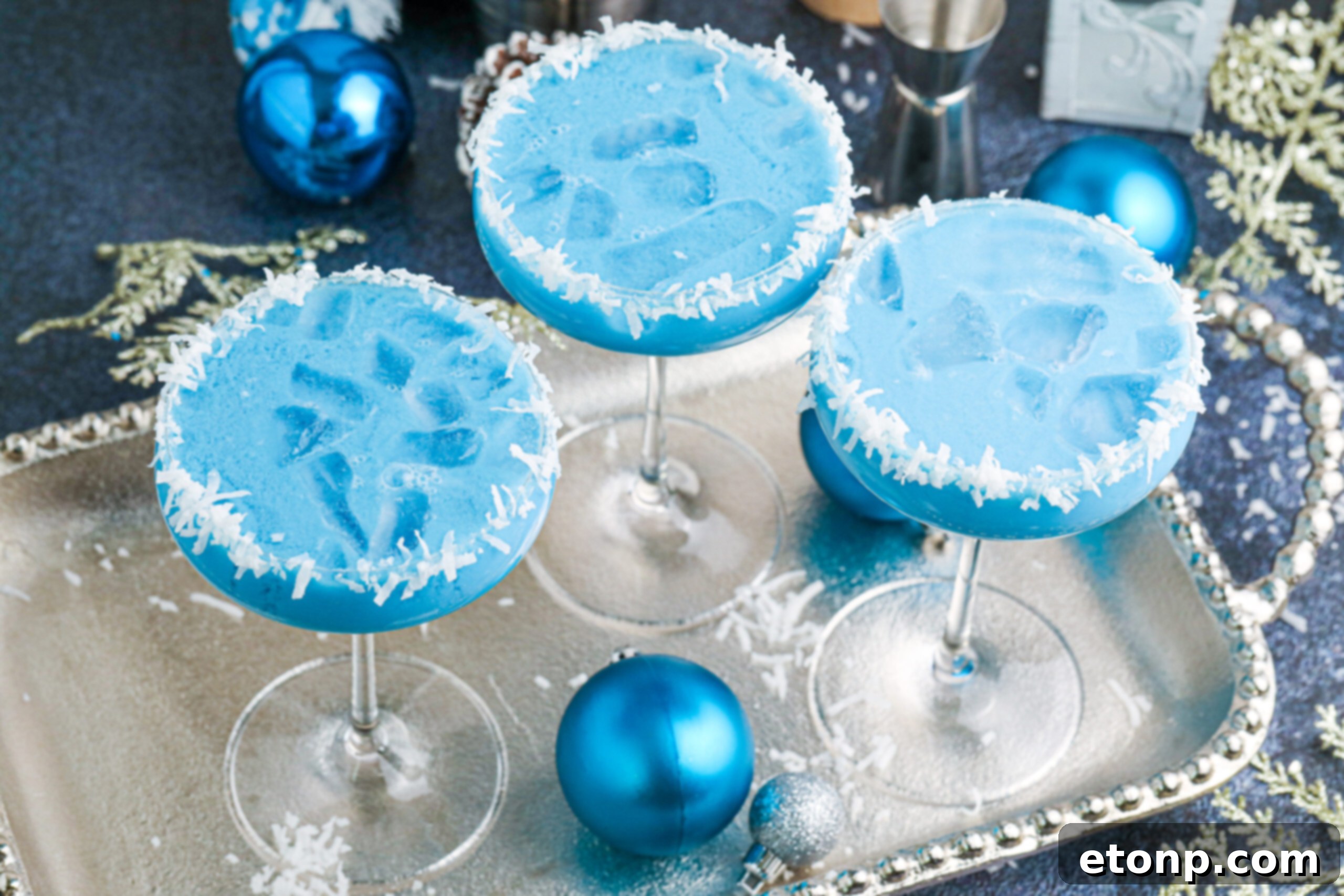 blue Christmas cocktails on a silver platter