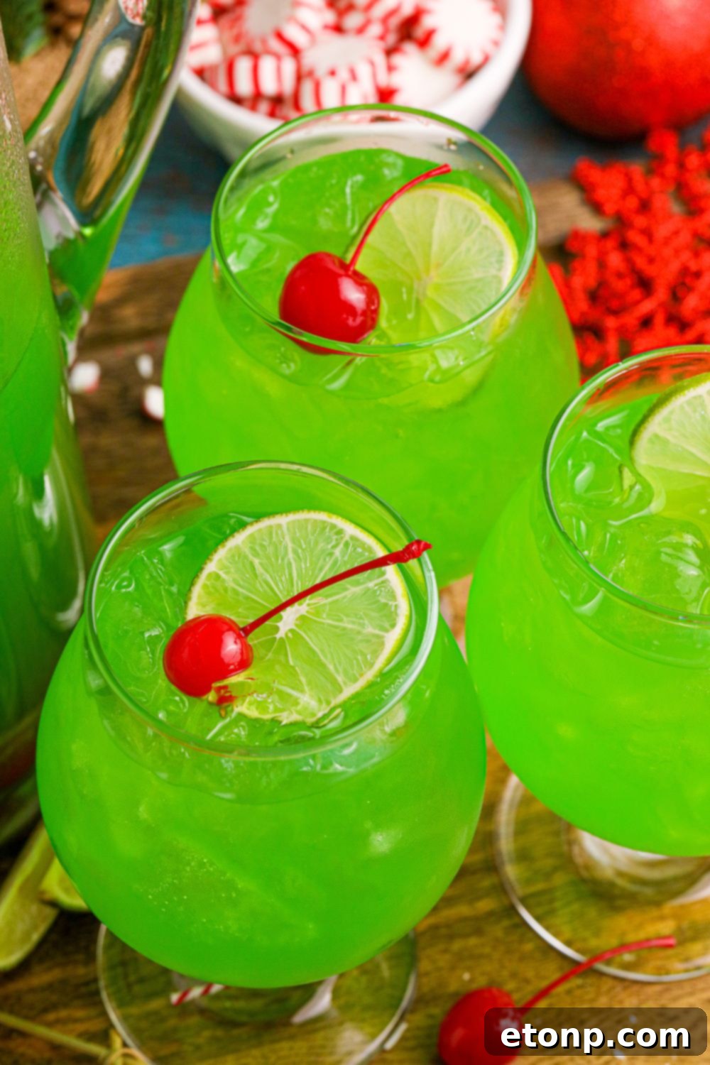 Glasses filled with vibrant green punch arranged on a table, creating an inviting display for a Christmas party.