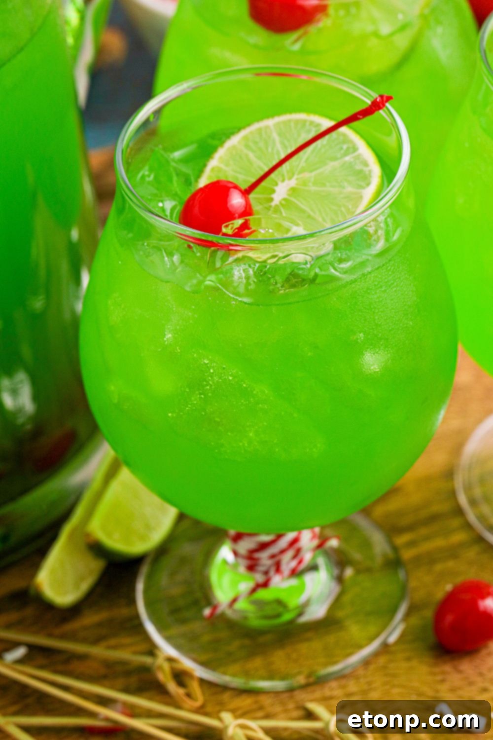 A cocktail glass filled with vibrant green, kid-friendly punch, showcasing its festive appeal.