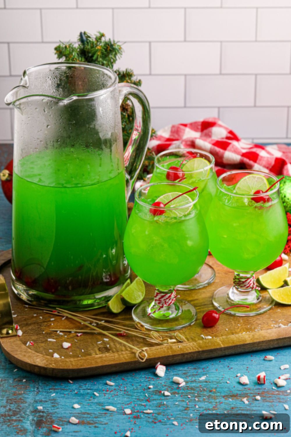 A display of Grinch Punch in glasses and a pitcher on a table, inviting guests to enjoy the festive beverage.
