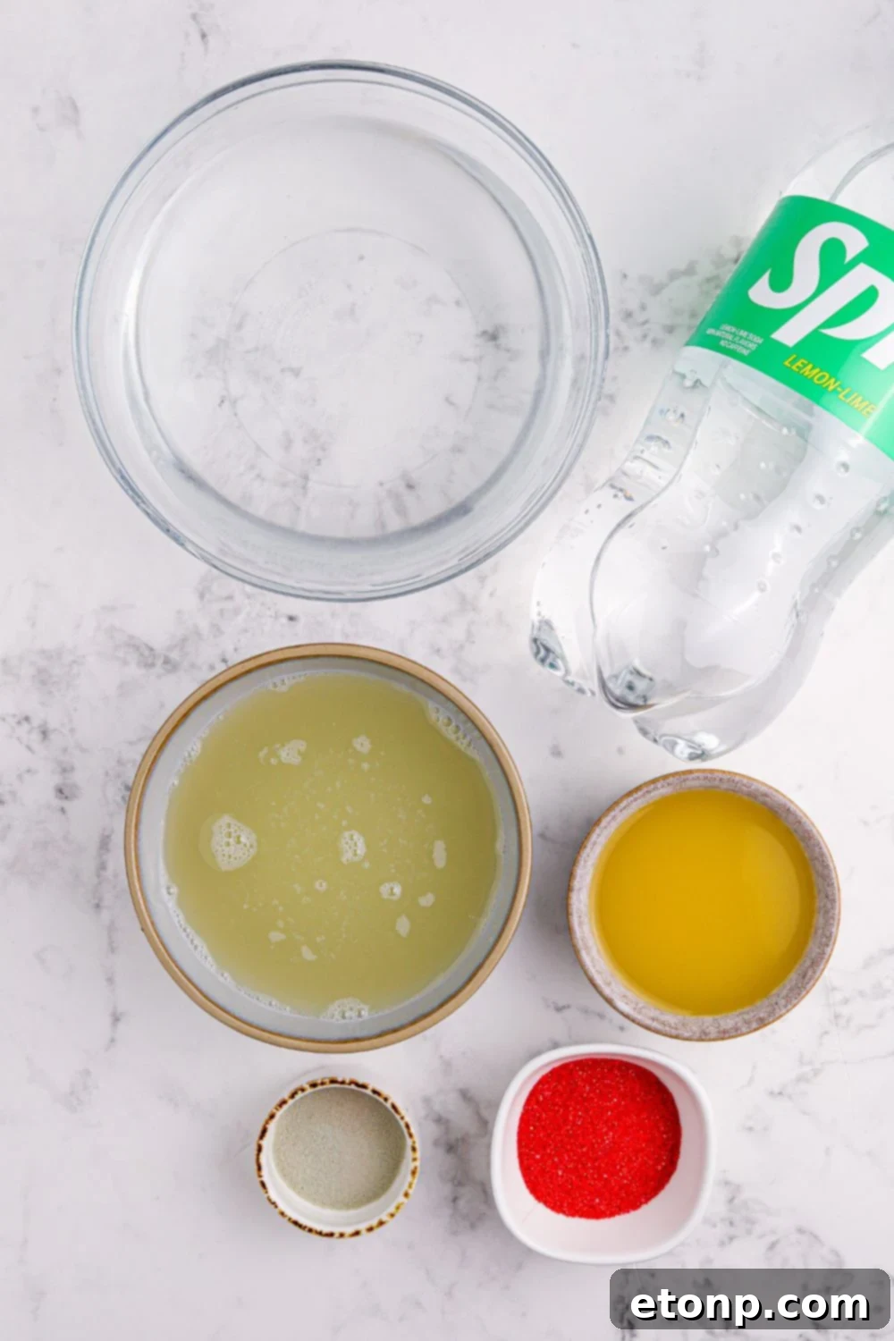 Key ingredients for making the vibrant green Grinch Punch laid out on a table.