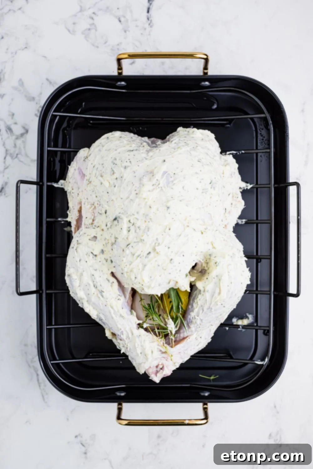 butterball turkey slathered with butter in a roasting pan