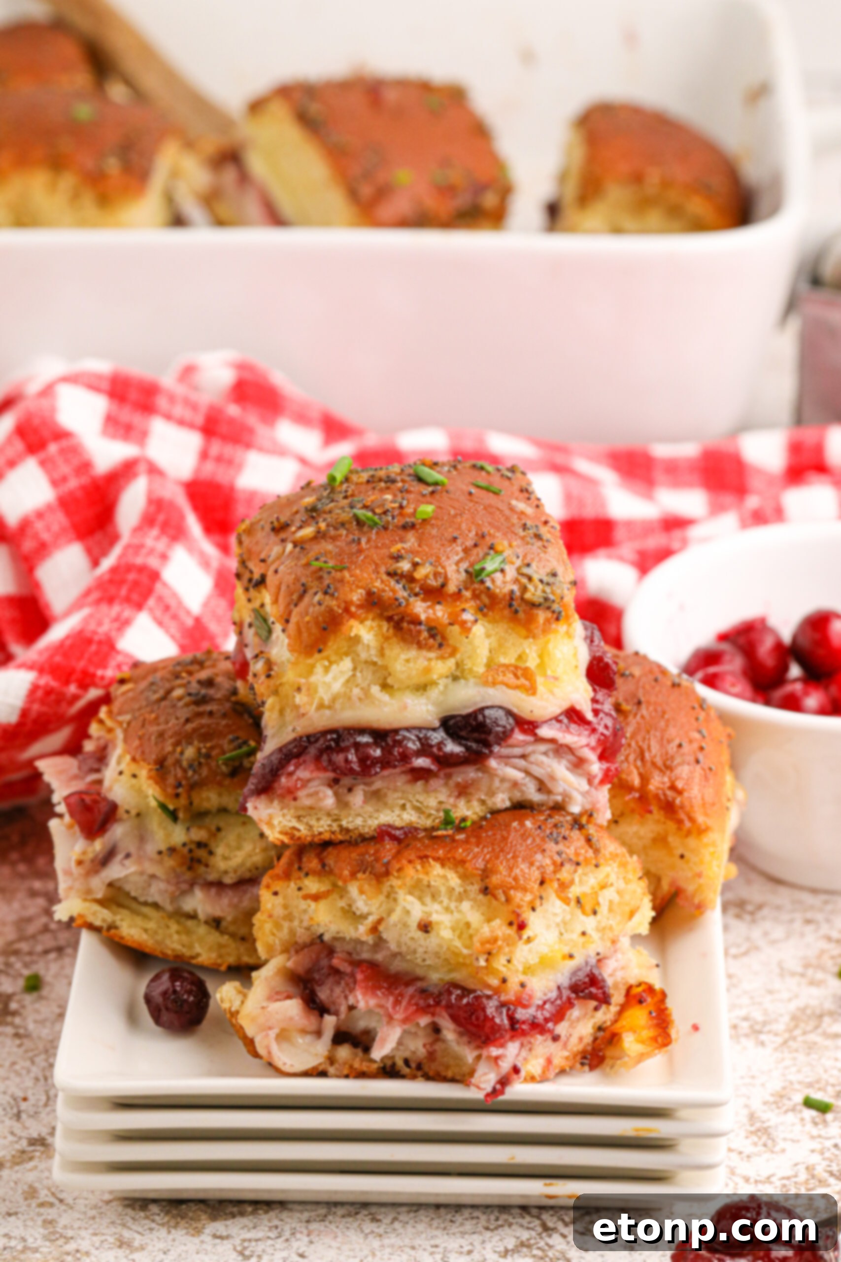 Festive Turkey Sliders 2 Thanksgiving Sliders stacked on white plates on table