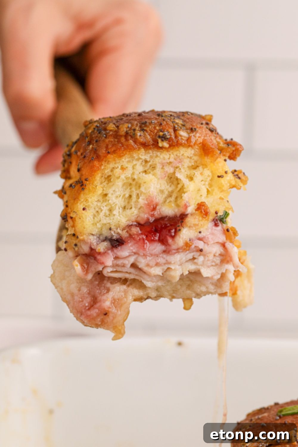 Festive Turkey Sliders 13 hawaiian slider on spatula above pan