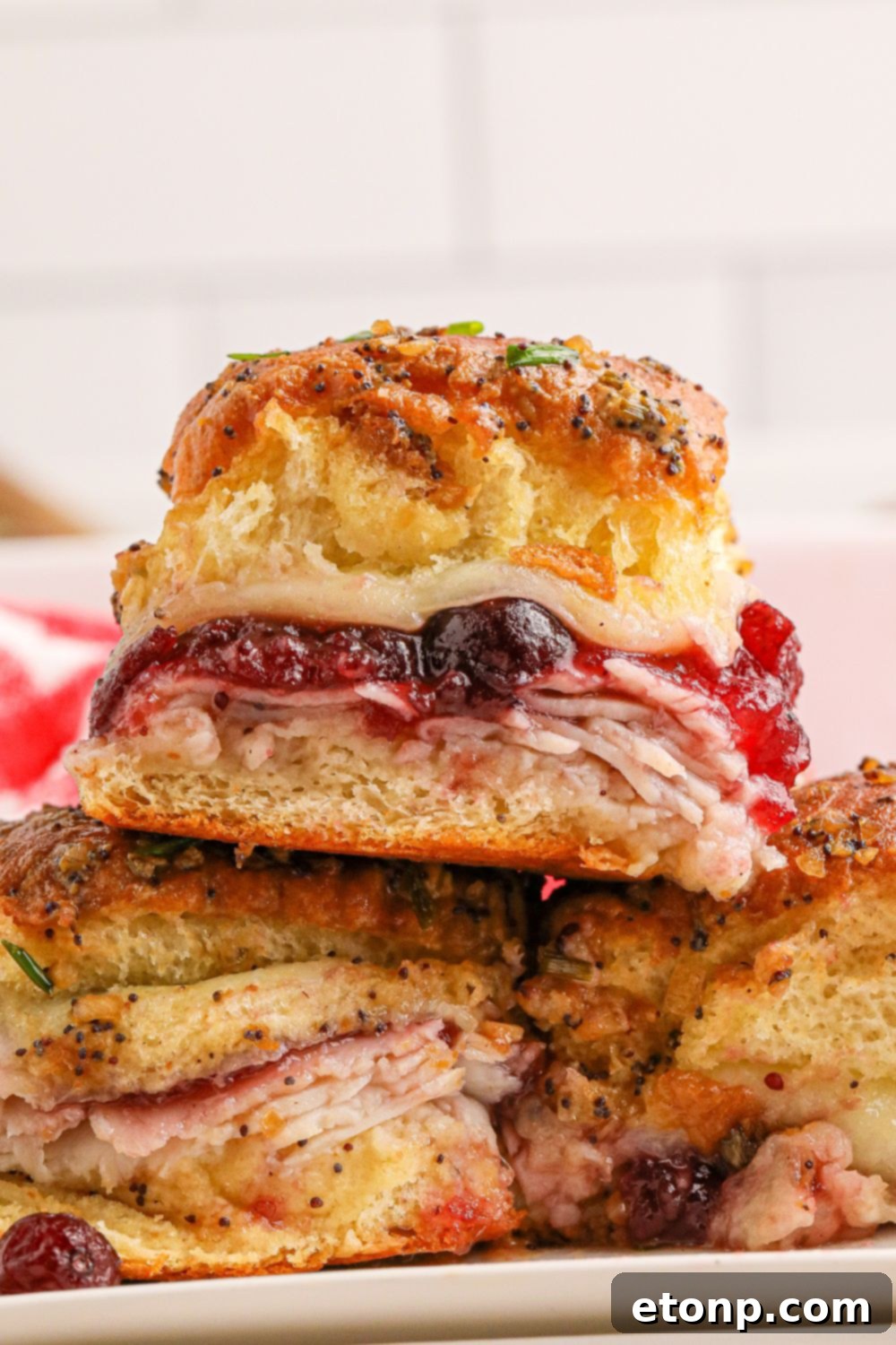 Festive Turkey Sliders 17 turkey sandwich with cranberries stacked on top of each other