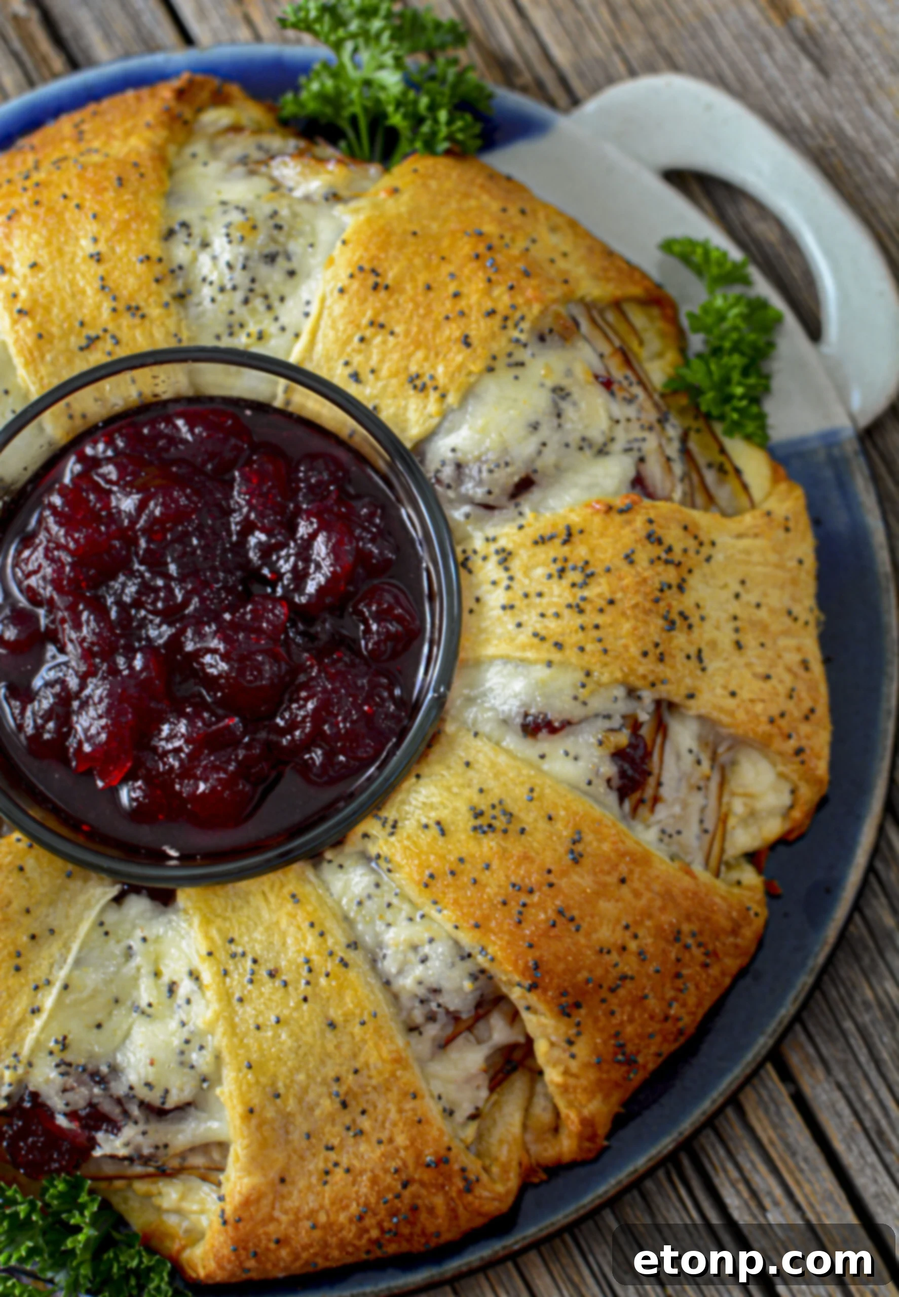Turkey Crescent Roll Ring over head shot with a bowl of cranberry sauce in the center 
